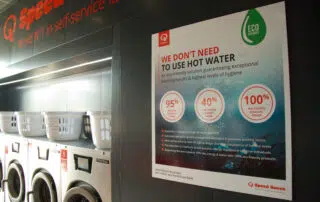 In a laundry room, a poster highlights the significance of water conservation, encouraging mindful usage of this vital resource.