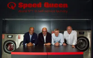 People celebrating the 1,000th opening Ireland Speed Queen Store, the world's first self-service laundry.