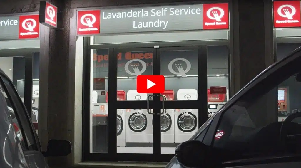 A video showcasing a laundry service store featuring a prominent sign that reads Speed Queen Laundry Service.